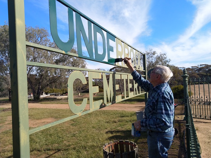 Ray repainting the sign